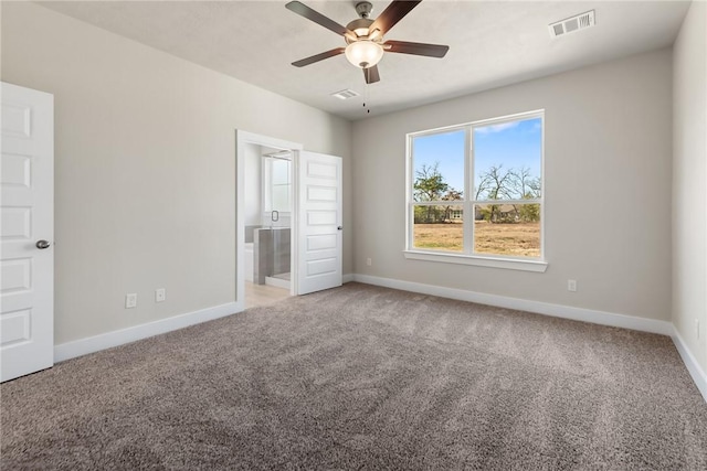 unfurnished bedroom with connected bathroom, carpet floors, and ceiling fan