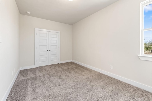 unfurnished bedroom with carpet floors and a closet