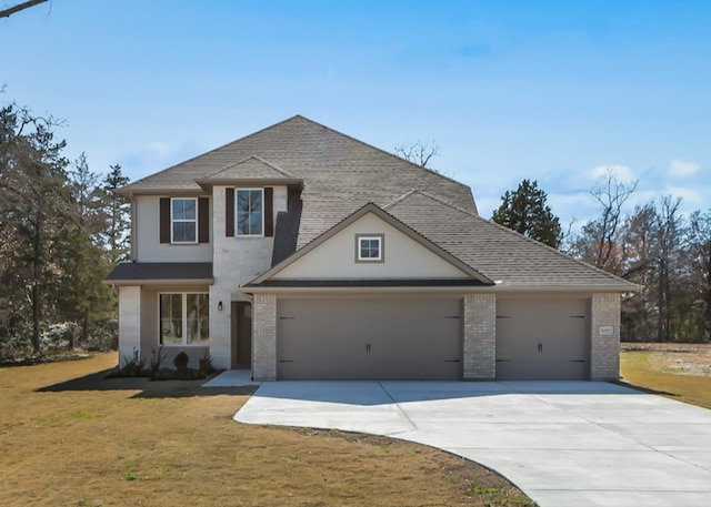 view of front facade featuring a garage and a front lawn