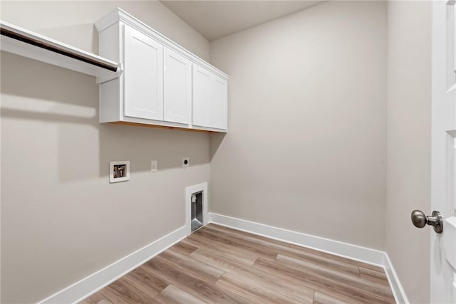 laundry area featuring cabinets, hookup for a washing machine, hookup for an electric dryer, and light wood-type flooring