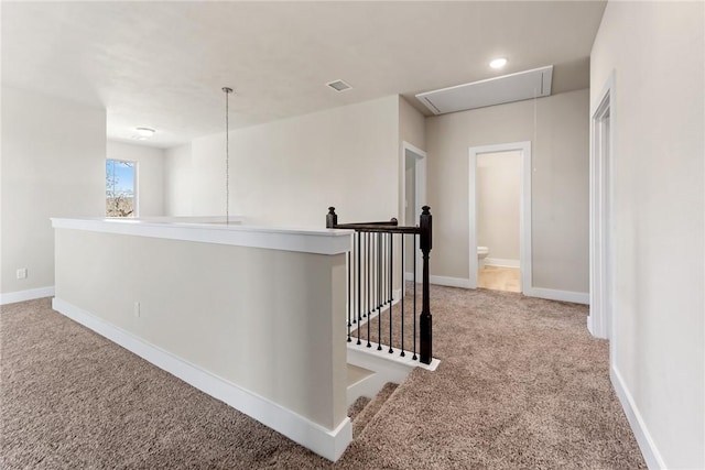 hallway with light colored carpet