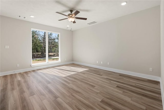 unfurnished room with ceiling fan and wood-type flooring