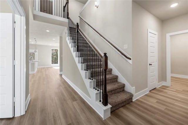 stairs featuring hardwood / wood-style flooring