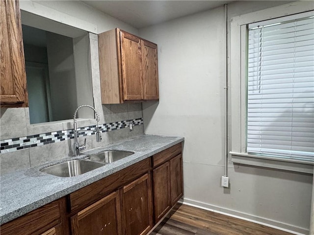 kitchen featuring dark hardwood / wood-style floors, sink, and tasteful backsplash