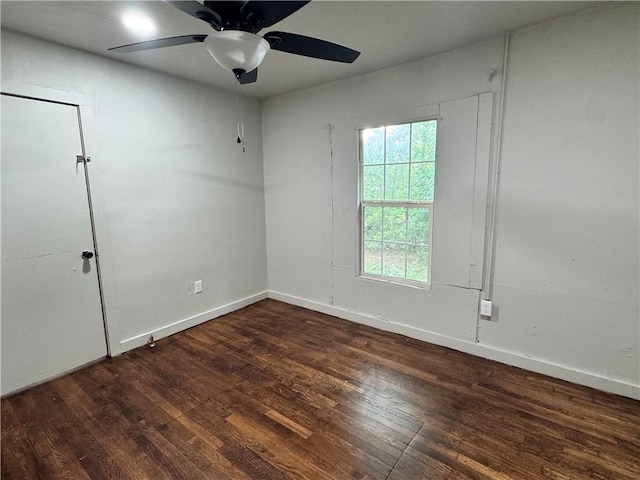 unfurnished room with ceiling fan and dark wood-type flooring