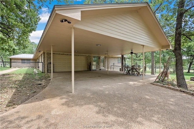 view of parking / parking lot featuring a carport, ceiling fan, and a garage