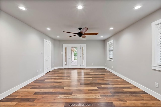 foyer entrance with dark hardwood / wood-style floors and ceiling fan