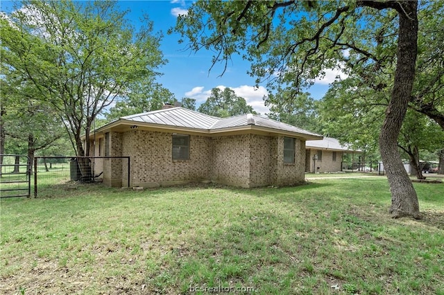 view of side of home featuring a lawn