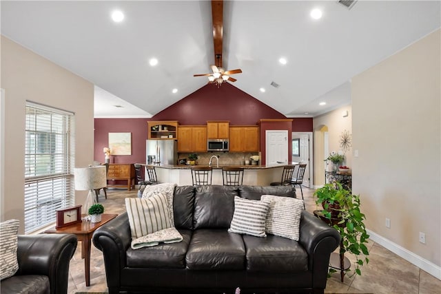 living area with recessed lighting, beam ceiling, high vaulted ceiling, a ceiling fan, and baseboards