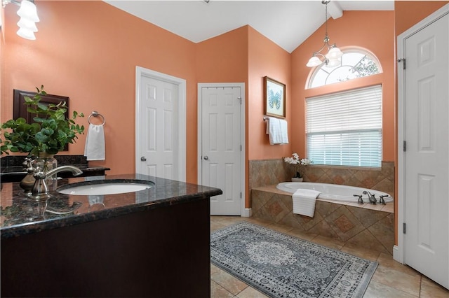 bathroom featuring a garden tub, lofted ceiling, a notable chandelier, and tile patterned floors