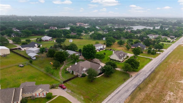 drone / aerial view featuring a residential view and a water view