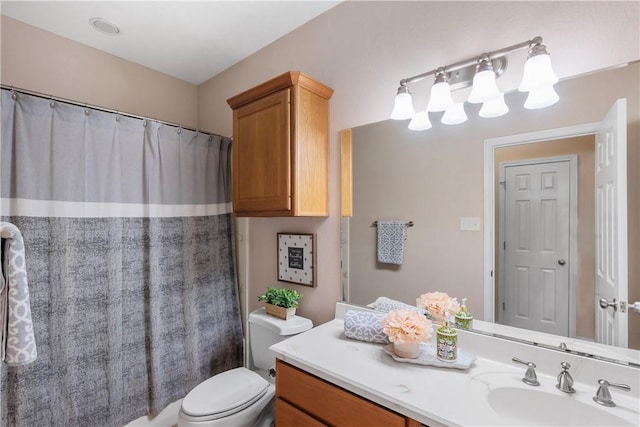 bathroom featuring toilet, a shower with curtain, and vanity