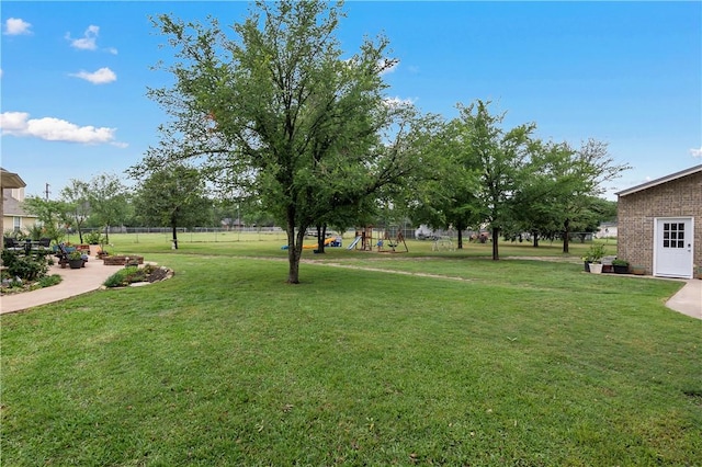 view of yard featuring fence and a playground