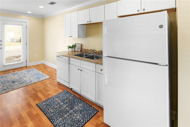 kitchen featuring visible vents, ornamental molding, a sink, white cabinetry, and white appliances