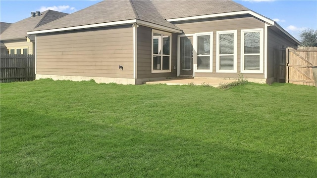 back of property with a patio area and a lawn