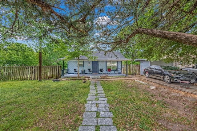 bungalow-style house featuring a front yard and fence