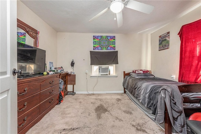 carpeted bedroom with cooling unit, a ceiling fan, and baseboards