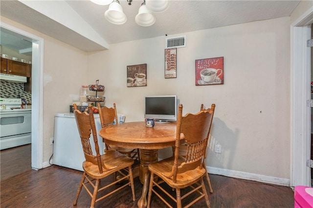 dining area featuring dark wood finished floors, visible vents, and baseboards