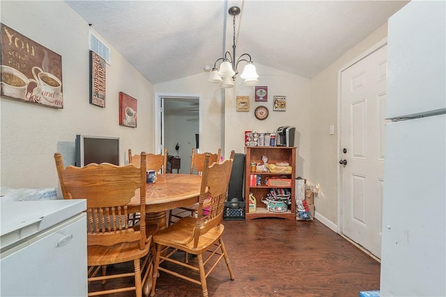 dining area featuring visible vents, baseboards, wood finished floors, an inviting chandelier, and vaulted ceiling