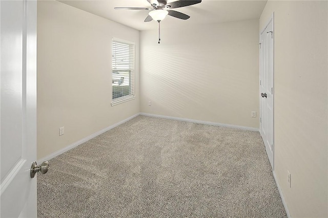 carpeted spare room with ceiling fan