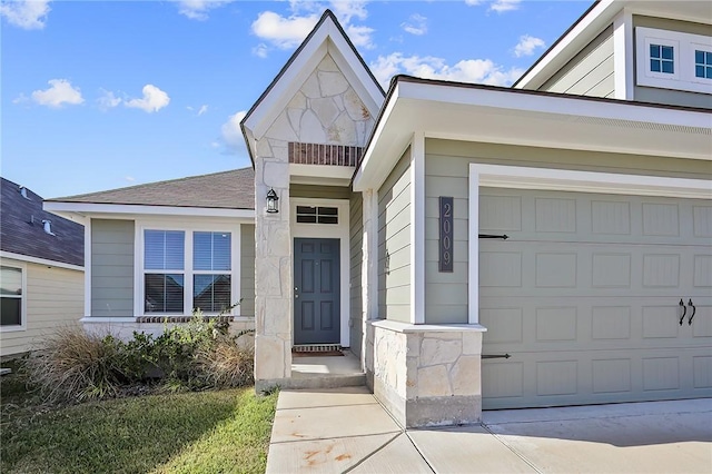 view of exterior entry with a garage