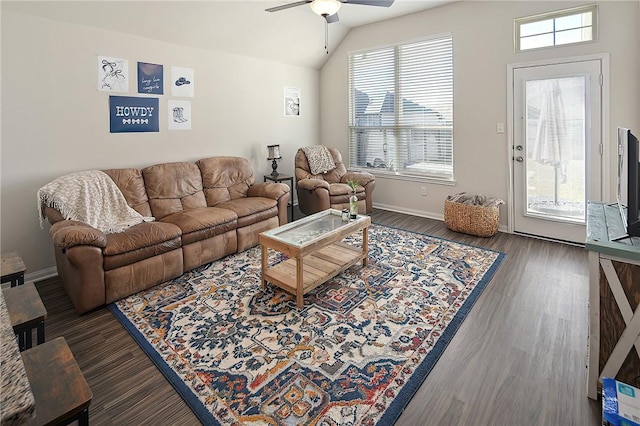 living room with ceiling fan, vaulted ceiling, a wealth of natural light, and dark hardwood / wood-style floors