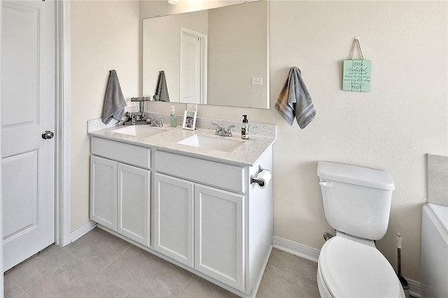 bathroom with tile patterned floors, vanity, and toilet