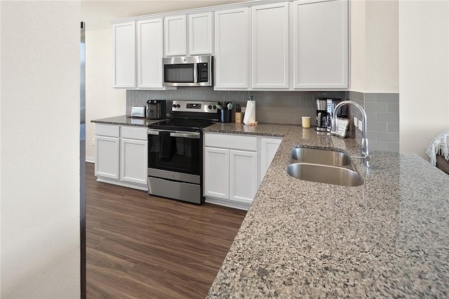 kitchen featuring appliances with stainless steel finishes, white cabinets, and sink