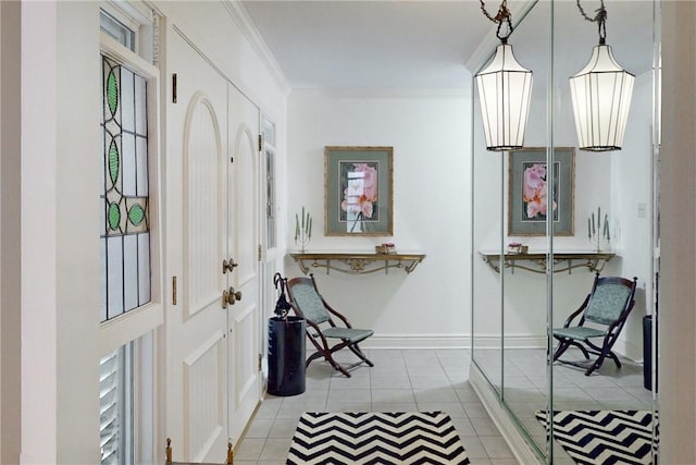 foyer featuring light tile patterned floors and ornamental molding