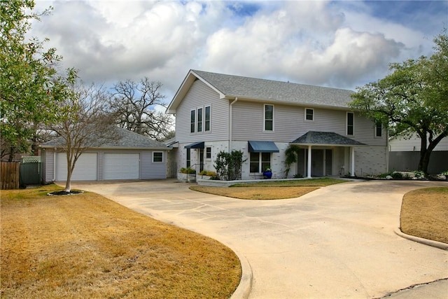 view of front of property featuring a garage and a front lawn