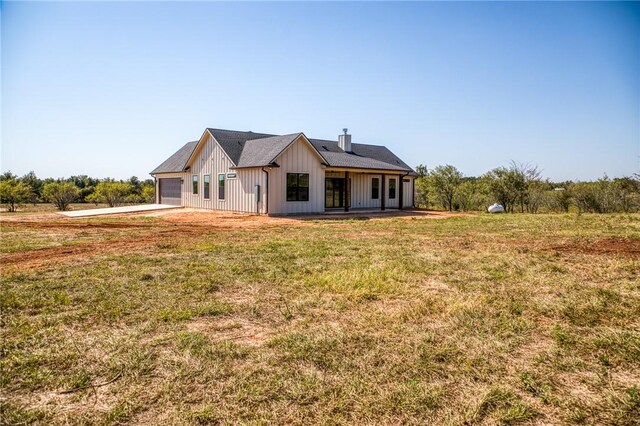 exterior space with a garage and a front lawn