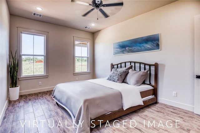 bedroom with ceiling fan and light hardwood / wood-style flooring