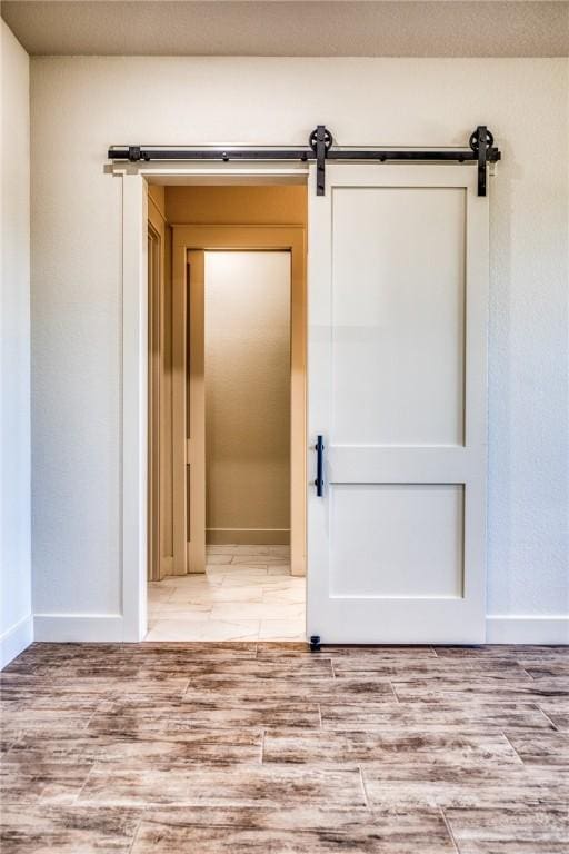 interior space featuring a barn door and light wood-type flooring