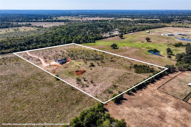 birds eye view of property featuring a rural view