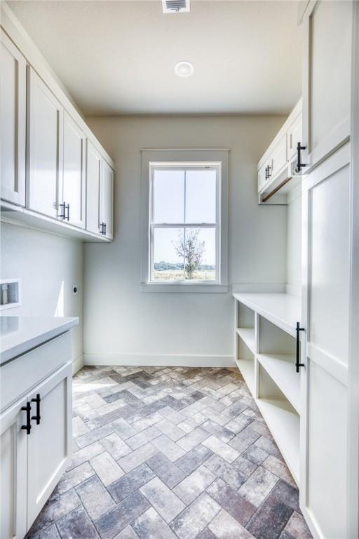 laundry room with hookup for a washing machine, cabinets, and hookup for an electric dryer