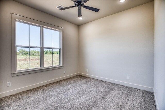 carpeted spare room featuring ceiling fan