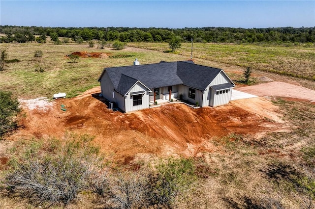 birds eye view of property with a rural view