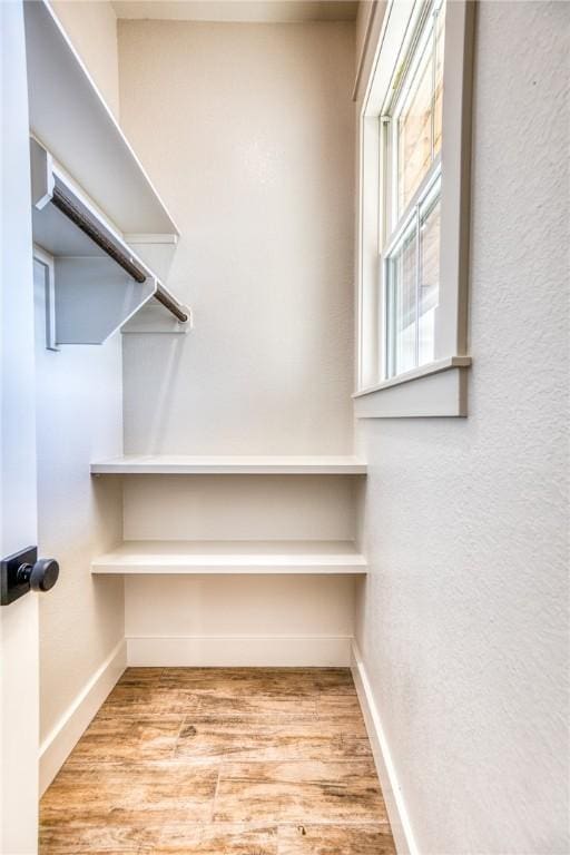 spacious closet featuring light wood-type flooring