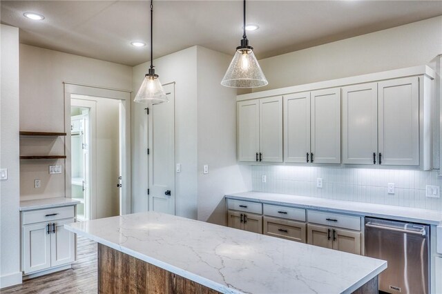 kitchen featuring light stone counters, decorative light fixtures, decorative backsplash, and dishwasher