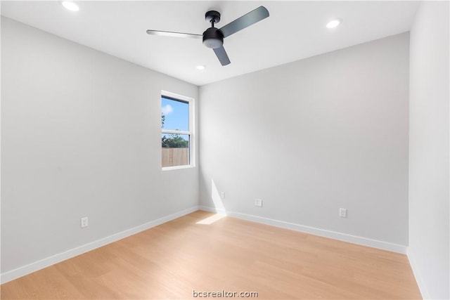 empty room with ceiling fan and light hardwood / wood-style flooring