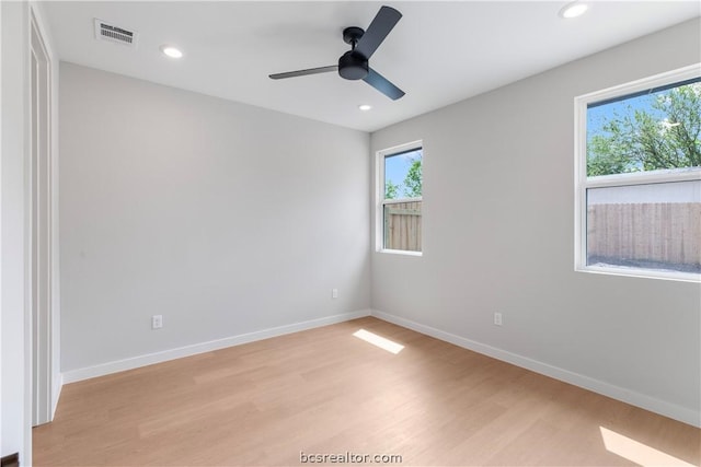 empty room with ceiling fan and light wood-type flooring