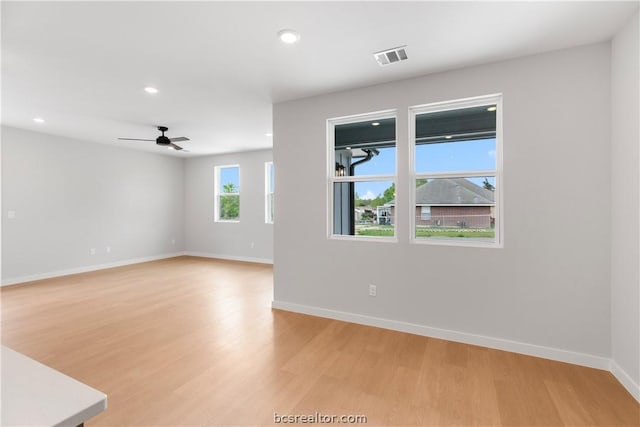 spare room featuring ceiling fan and light hardwood / wood-style flooring