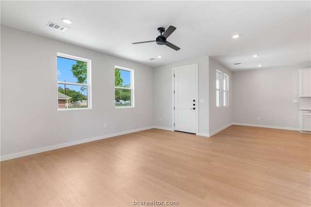 unfurnished living room with ceiling fan and light wood-type flooring