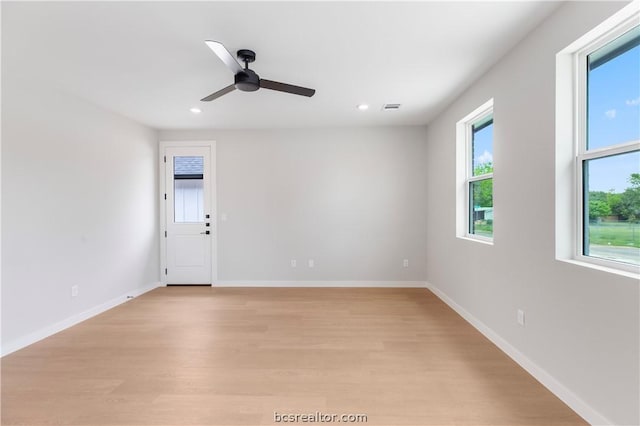 spare room with ceiling fan and light wood-type flooring