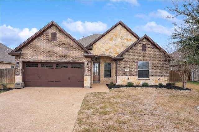 view of front of house featuring brick siding, concrete driveway, fence, a garage, and stone siding