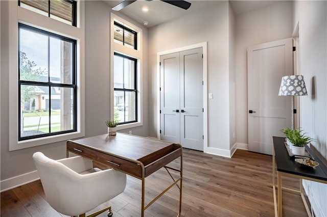 office with wood-type flooring and ceiling fan