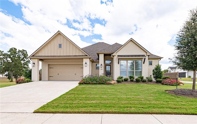 view of front facade featuring board and batten siding, a front yard, driveway, and a garage