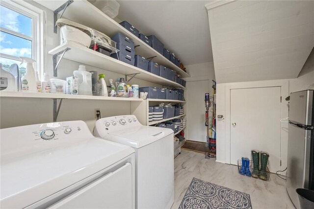 clothes washing area with separate washer and dryer, marble finish floor, and laundry area