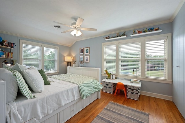 bedroom with visible vents, ornamental molding, light wood-type flooring, and a ceiling fan