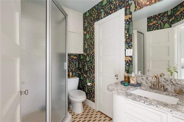 301 Hensel Ave, Bryan, TX 77801 - full bathroom featuring wallpapered walls, a shower stall, toilet, and vanity